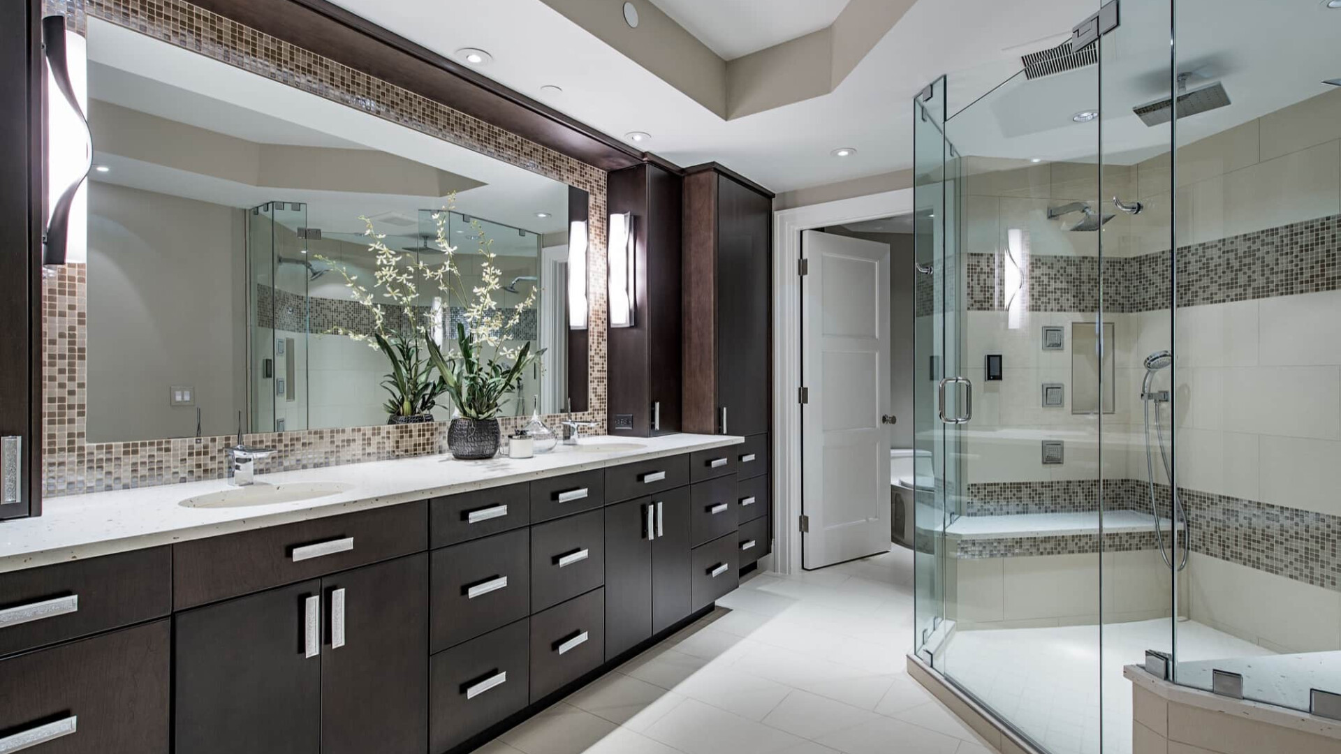 Luxury primary bathroom boasting custom cabinetry and a walk-in shower, Naples FL