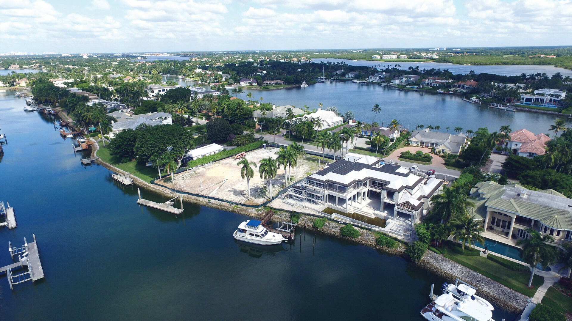 Aerial view of Port Royal custom waterfront home with a private dock, Naples FL