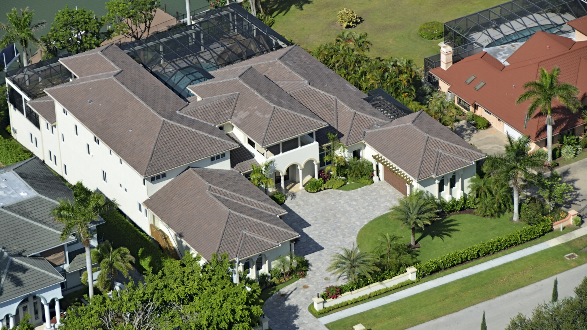 Aerial view of custom Mediterranean style home on the water, Naples FL